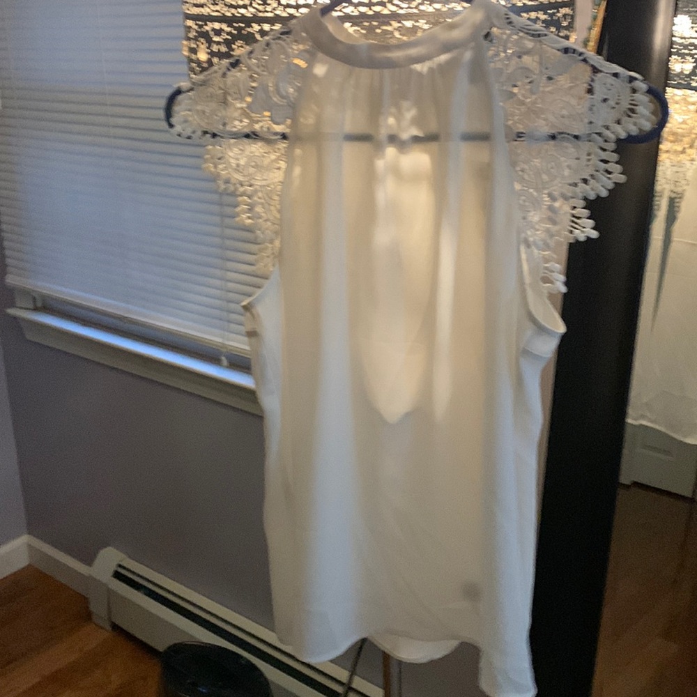 Sheer white, high neck blouse with detailed cap sleeves!